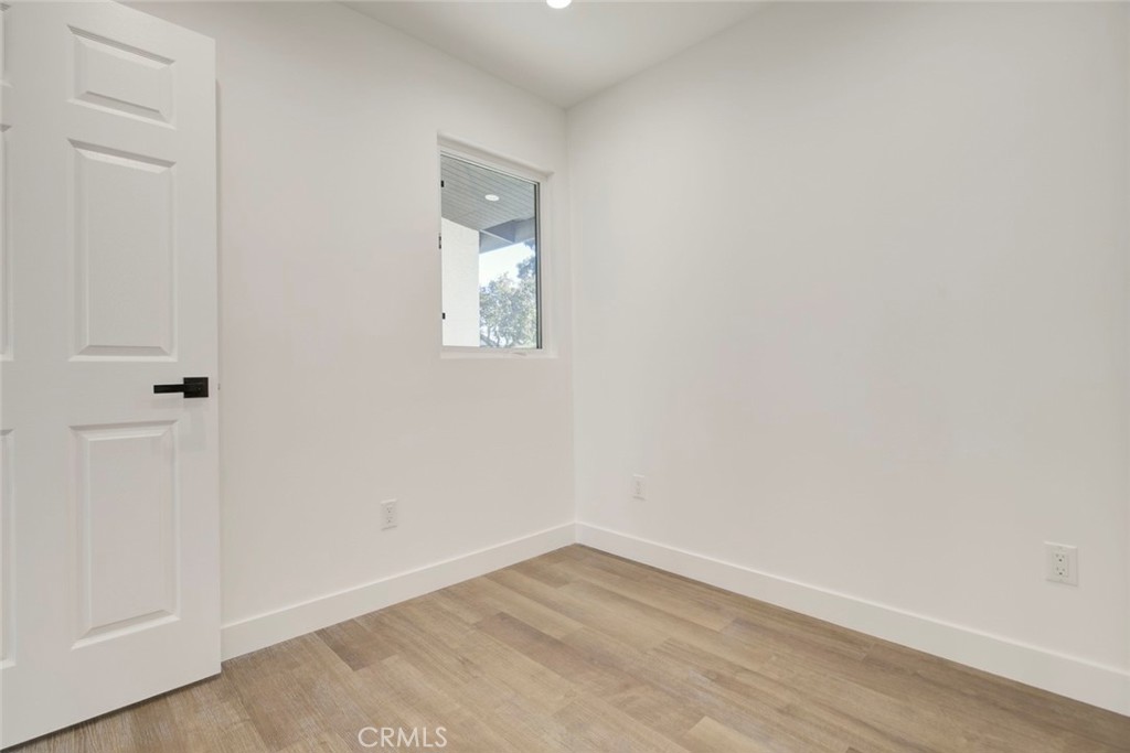 9055 Forbes Avenue Northridge, CA 91343 - Photo 24 of 62 a view of an empty room with wooden floor and a window