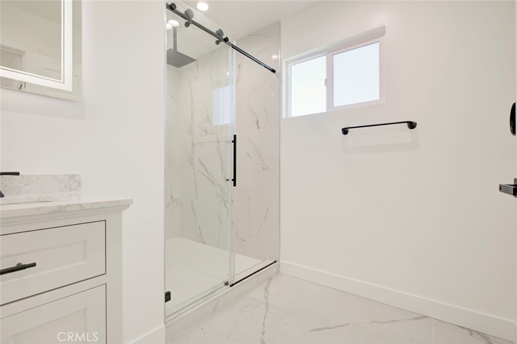 9055 Forbes Avenue Northridge, CA 91343 - Photo 33 of 62 a bathroom with a shower and a sink