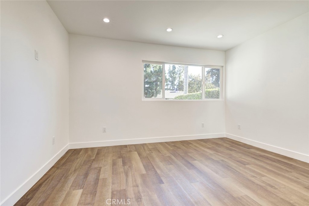 9055 Forbes Avenue Northridge, CA 91343 - Photo 39 of 62 an empty room with wooden floor and windows
