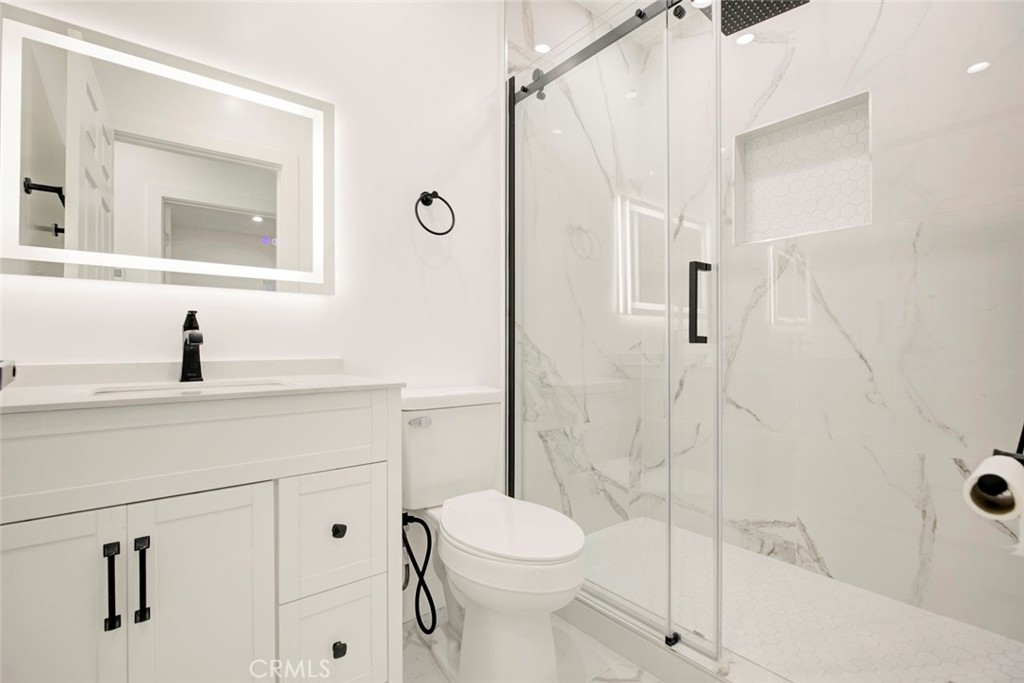 9055 Forbes Avenue Northridge, CA 91343 - Photo 60 of 62 a bathroom with a sink a toilet and shower