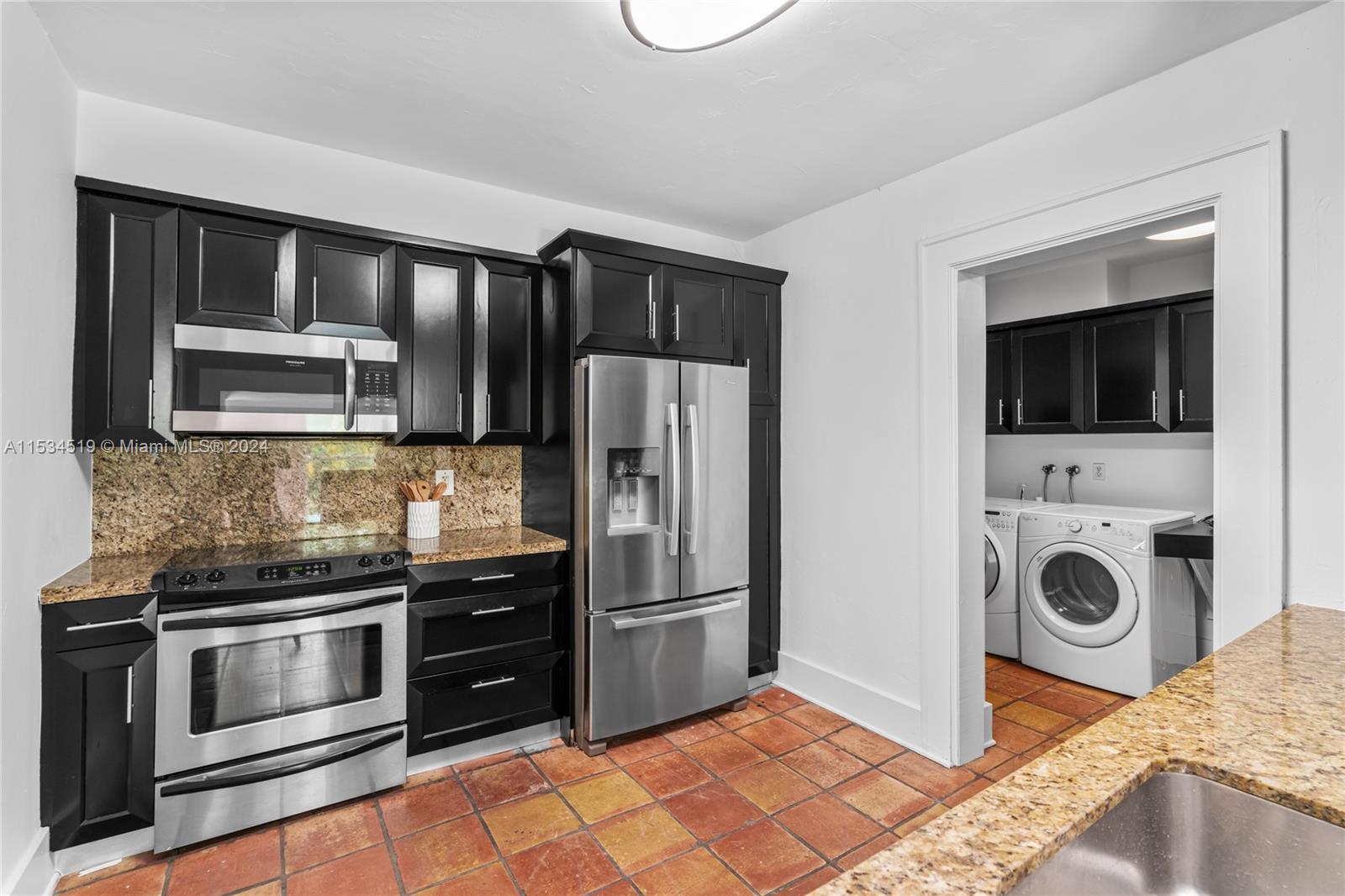 3871 South Le Jeune Road Miami, FL 33146 - Photo 15 of 49 a kitchen with a refrigerator stove and microwave