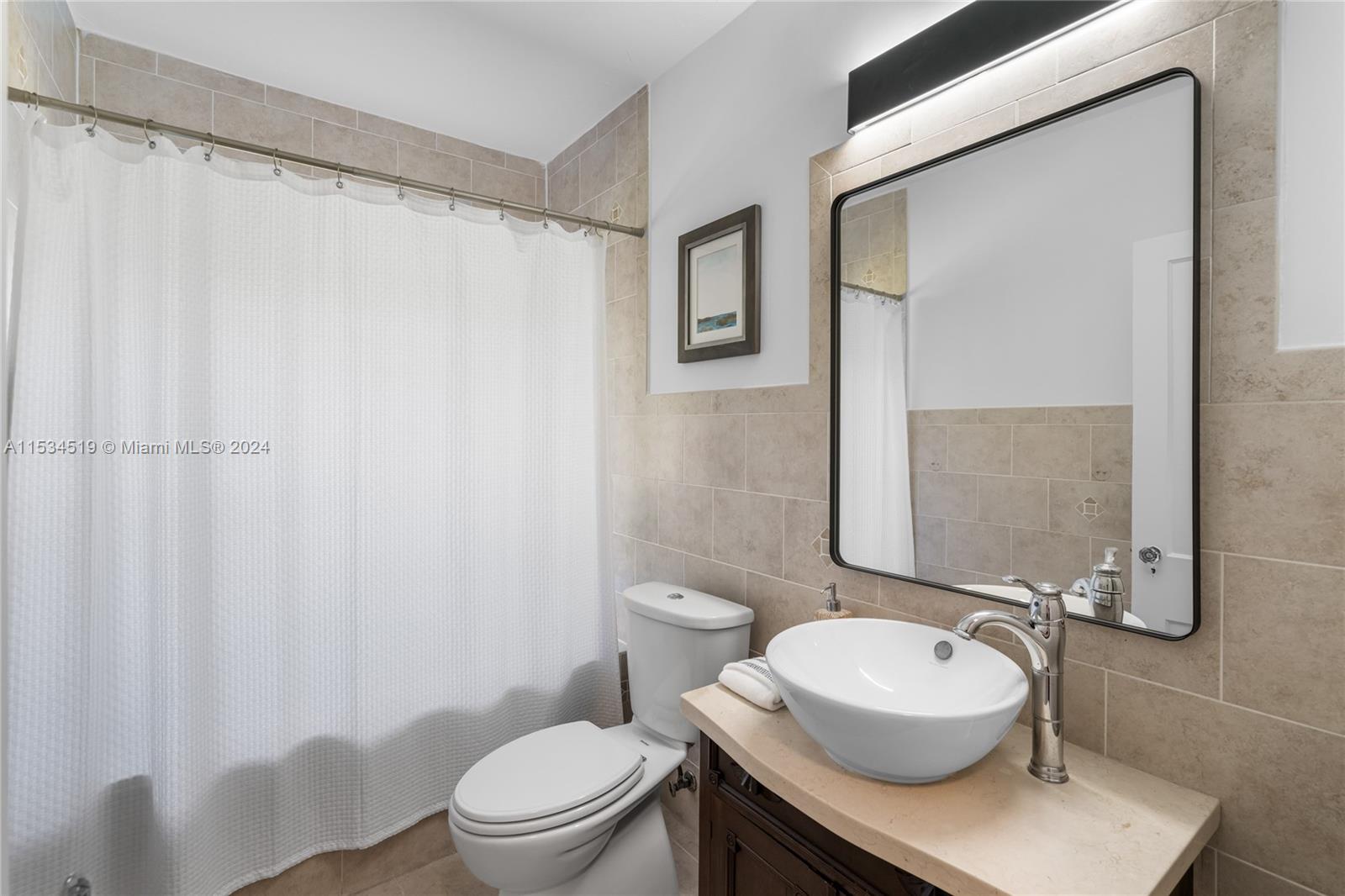 3871 South Le Jeune Road Miami, FL 33146 - Photo 18 of 49 a bathroom with a sink and a mirror