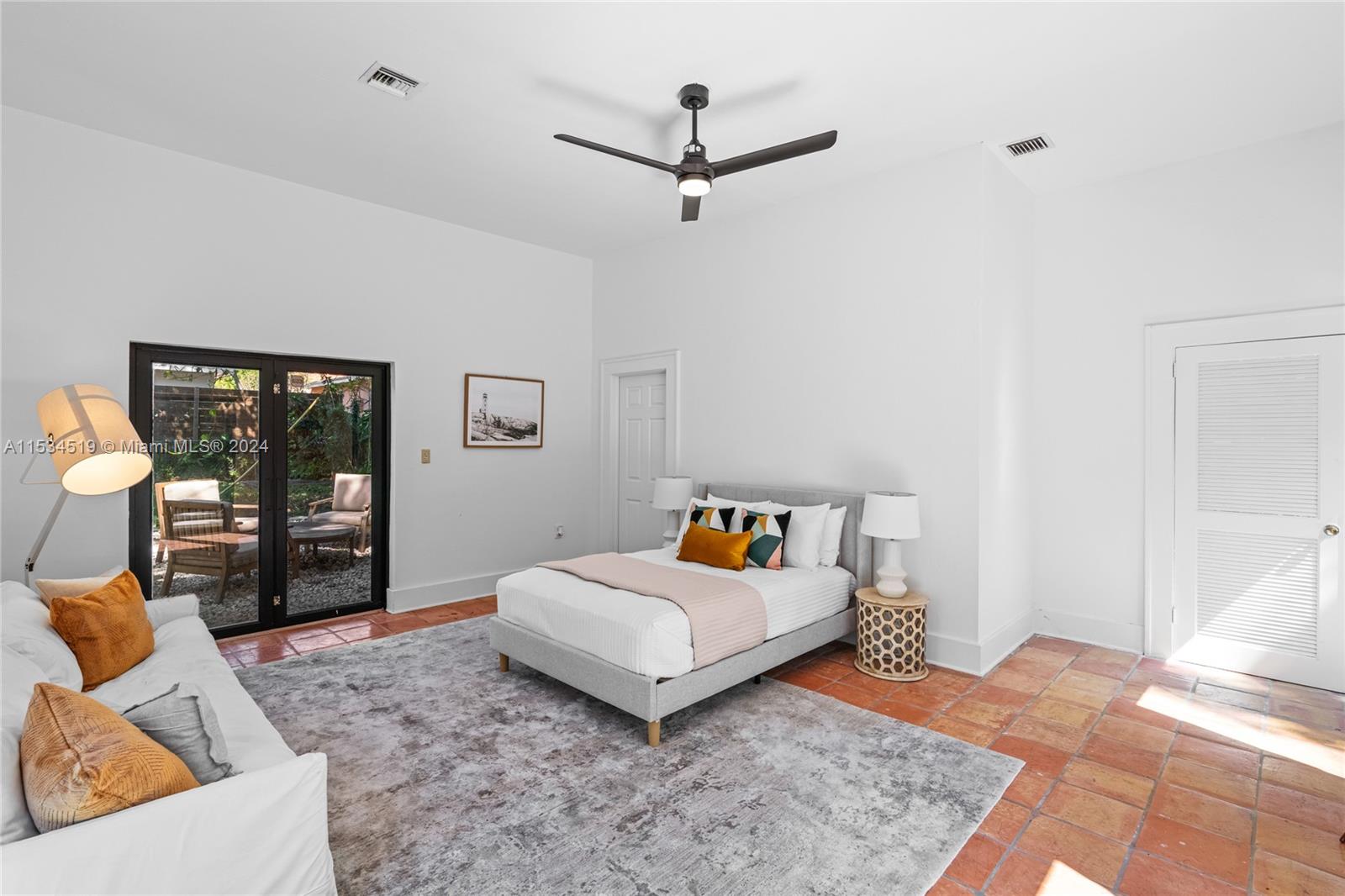 3871 South Le Jeune Road Miami, FL 33146 - Photo 27 of 49 a bedroom with a bed and glass door