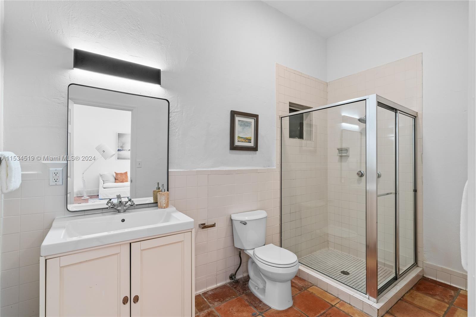 3871 South Le Jeune Road Miami, FL 33146 - Photo 30 of 49 a bathroom with a toilet a sink a mirror and shower