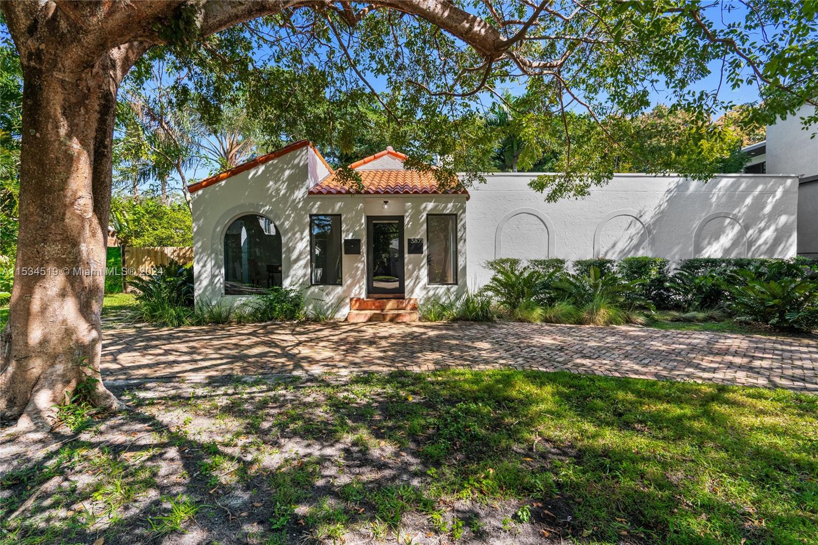 3871 South Le Jeune Road Miami, FL 33146 - Photo 3 of 49 a front view of a house with a garden