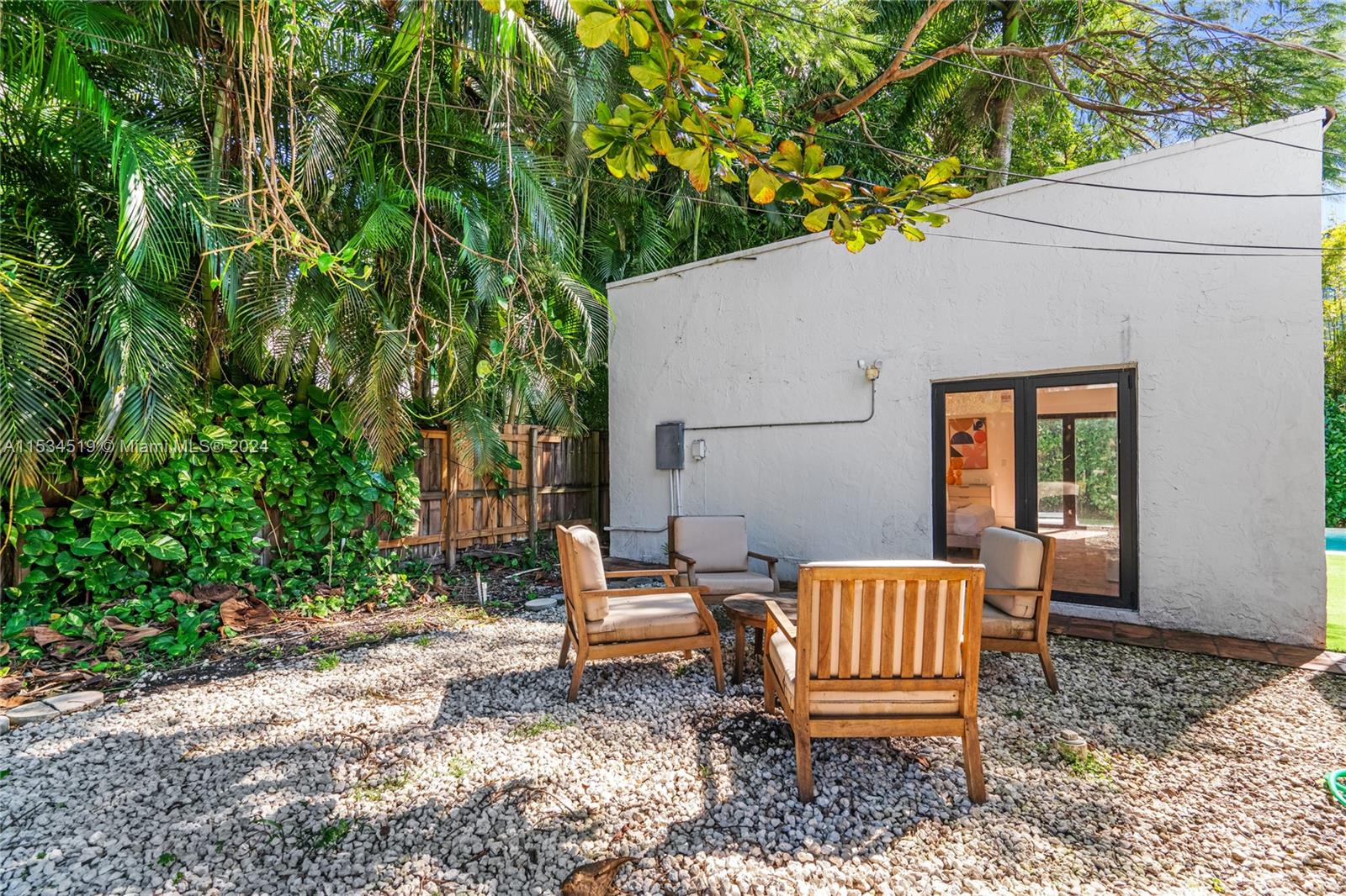 3871 South Le Jeune Road Miami, FL 33146 - Photo 32 of 49 a wooden bench sitting in backyard of a house
