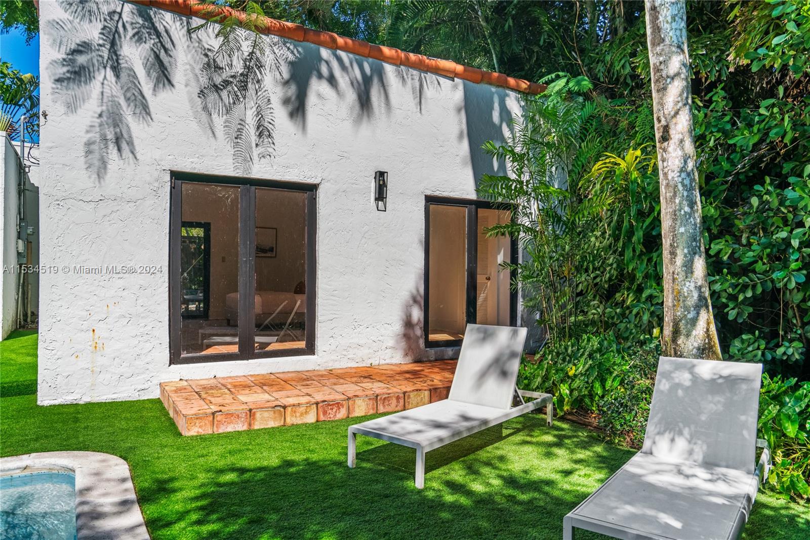 3871 South Le Jeune Road Miami, FL 33146 - Photo 36 of 49 a view of a chair and table in backyard of the house