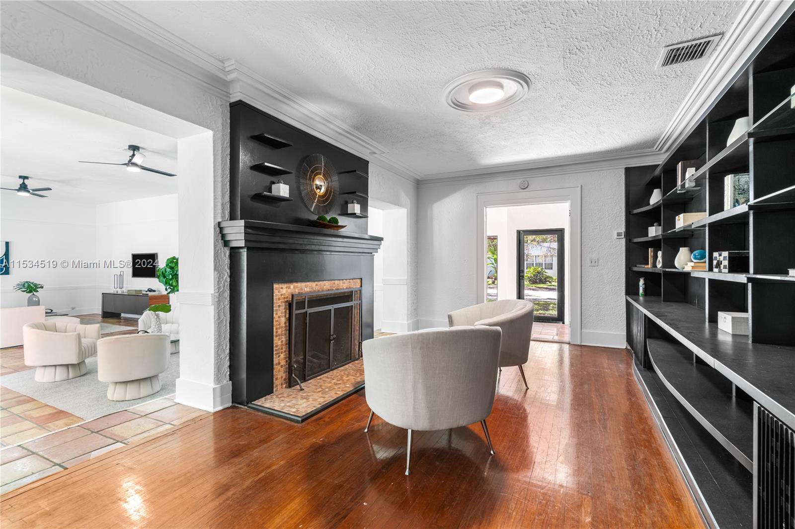 3871 South Le Jeune Road Miami, FL 33146 - Photo 8 of 49 a living room with furniture a flat screen tv and a fireplace