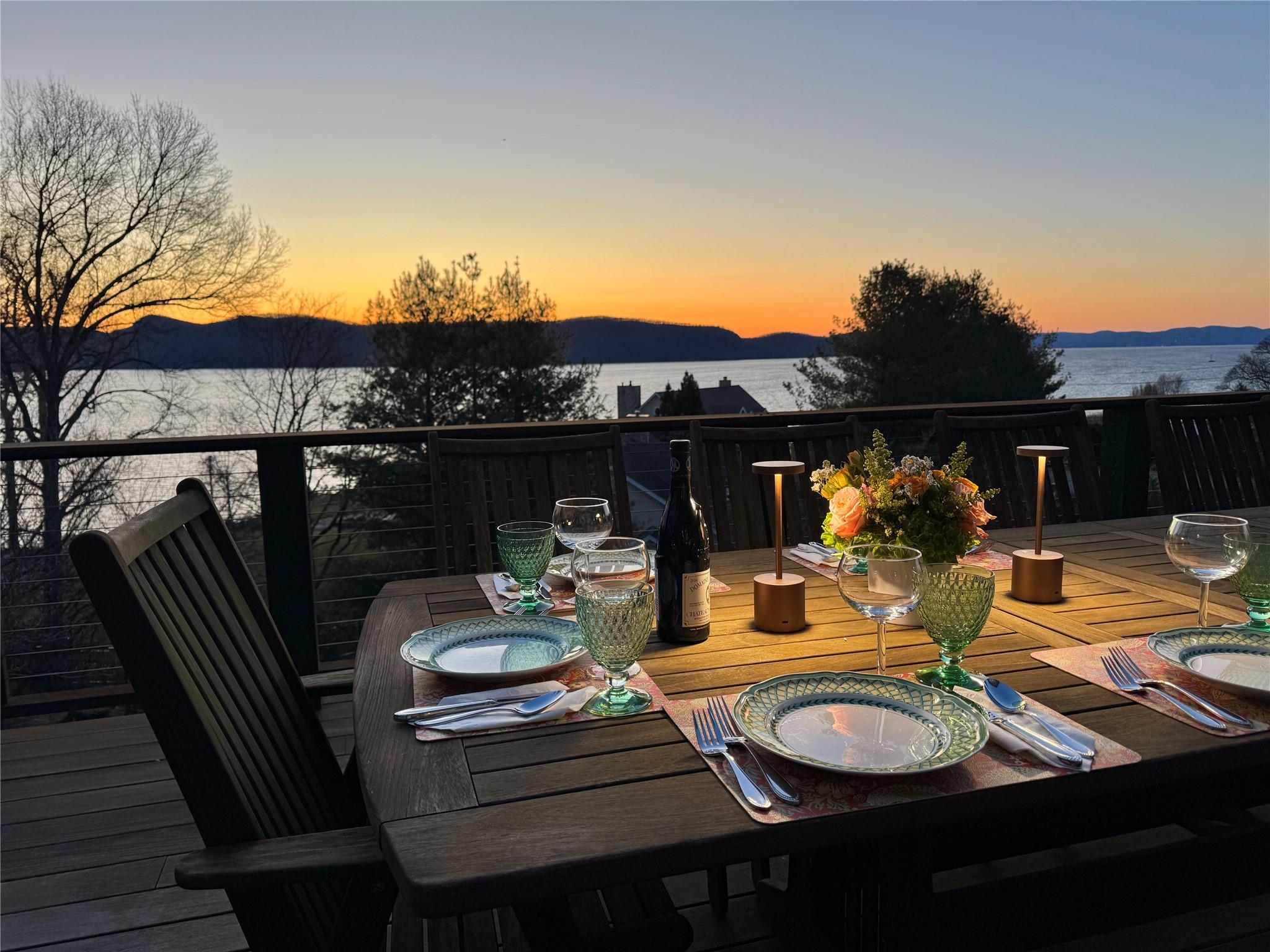 24 Country Club Lane Briarcliff Manor, NY 10510 - Photo 1 of 42 a view of a patio with table and chairs under an umbrella with wooden floor