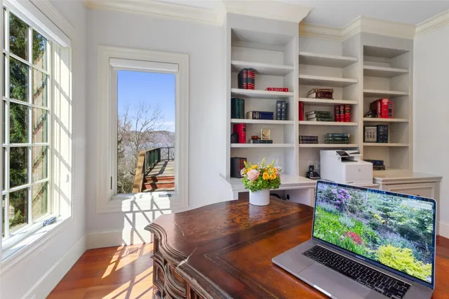 a dining room with lots of furniture and a book shelf