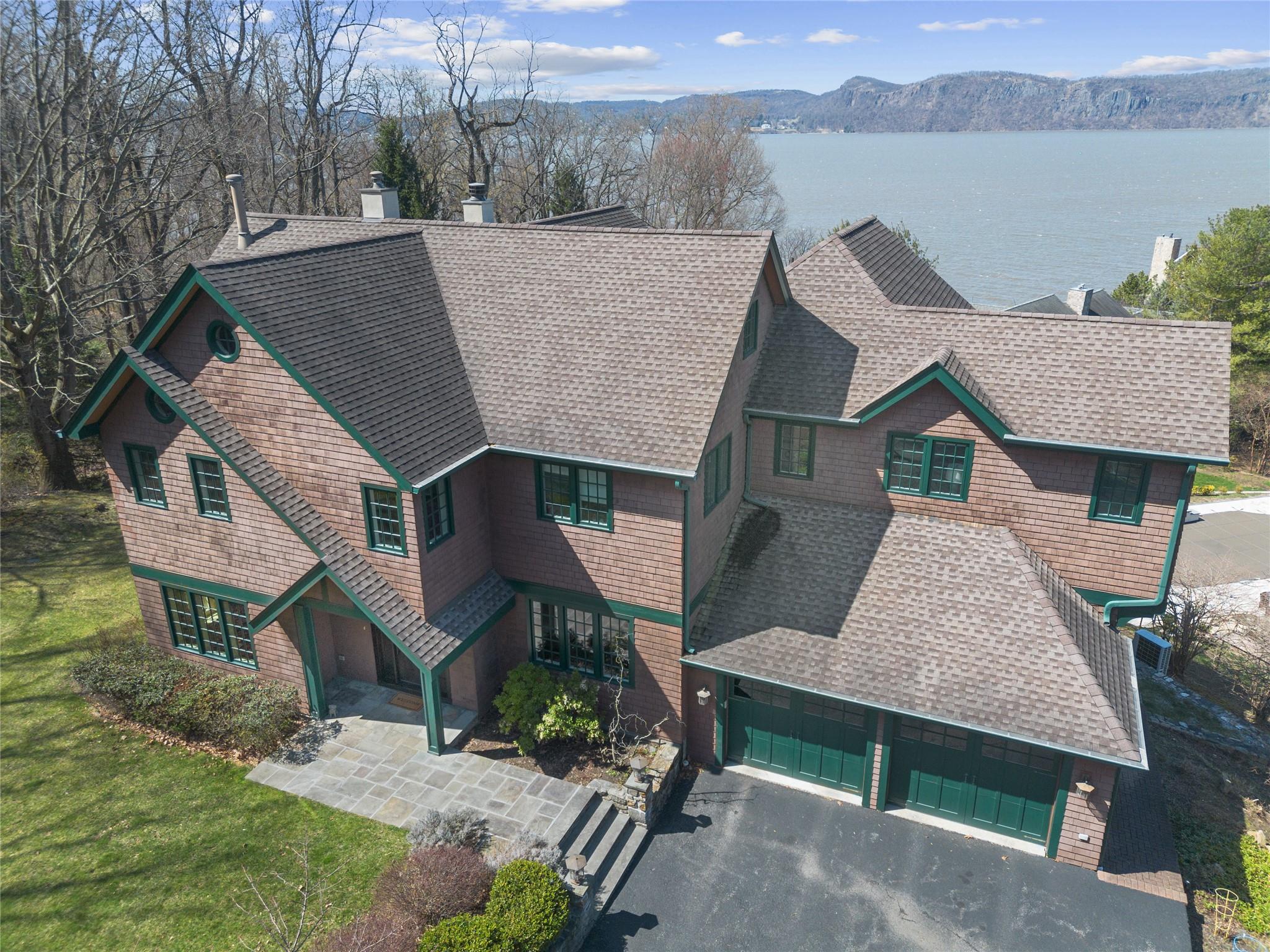 24 Country Club Lane Briarcliff Manor, NY 10510 - Photo 2 of 42 an aerial view of a house with lake view and a yard