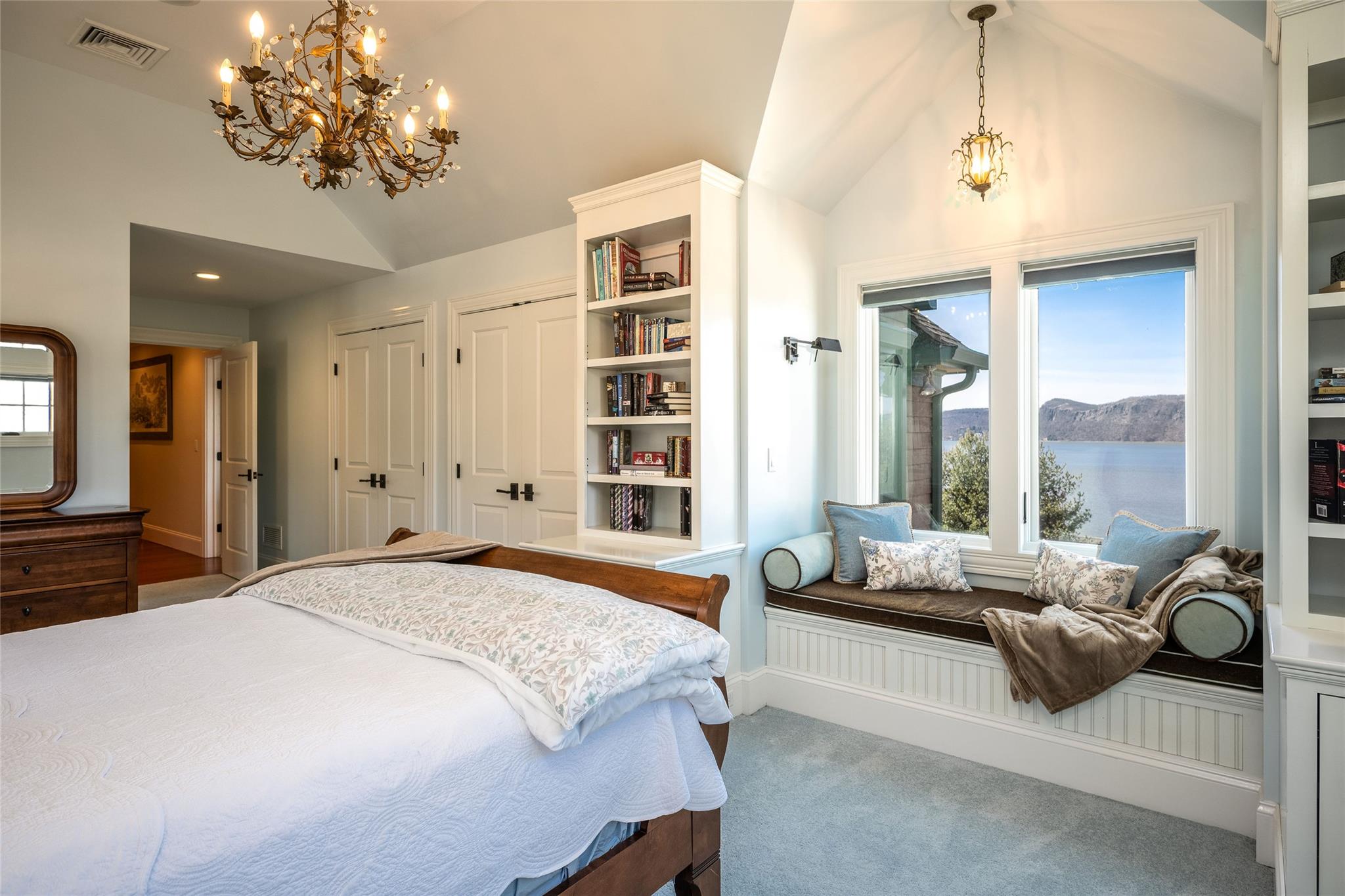 24 Country Club Lane Briarcliff Manor, NY 10510 - Photo 21 of 42 a spacious bedroom with a balcony a bed and a chandelier