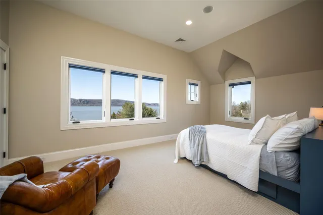 a bed sitting in a bedroom next to a window