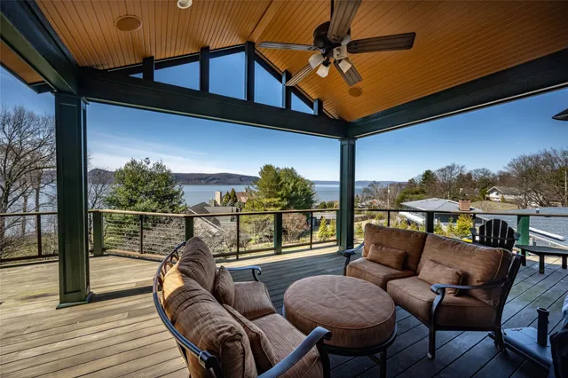 a balcony with furniture and wooden floor