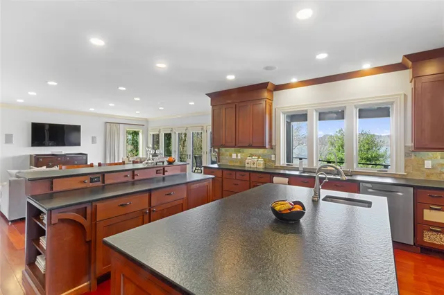 a kitchen with a large counter top appliances and cabinets