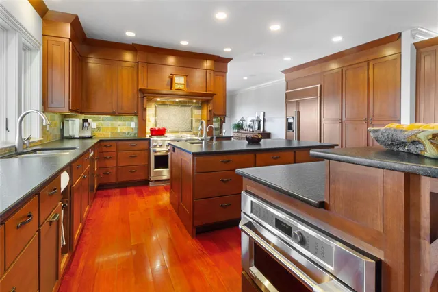 a kitchen with a sink appliances cabinets and a counter top space