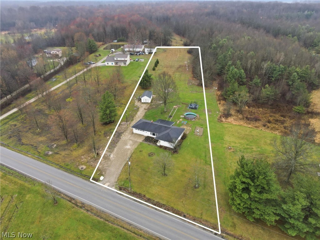 14557 Ellsworth Road Berlin Center, OH 44401 - Photo 3 of 23 Aerial view of property and surrounding area with property boundaries highlighted and a heavily wooded area