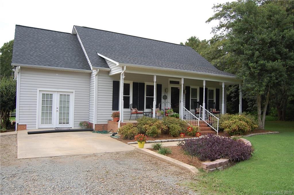 a front view of a house with garden and porch