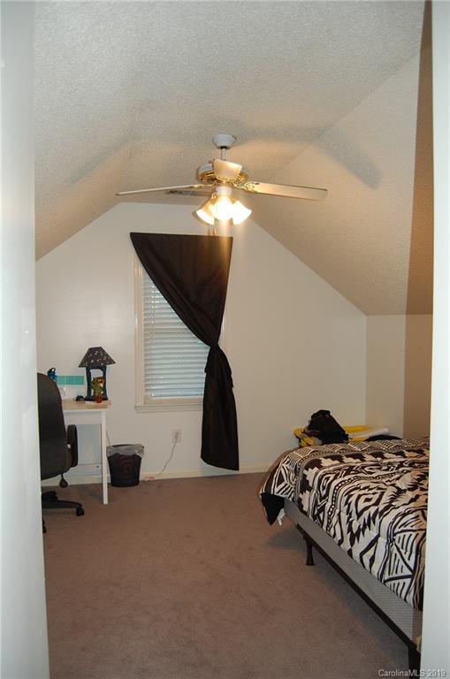 4385 Rimer Road Concord, NC 28025 - Photo 23 of 34 a bedroom with a bed and a chandelier