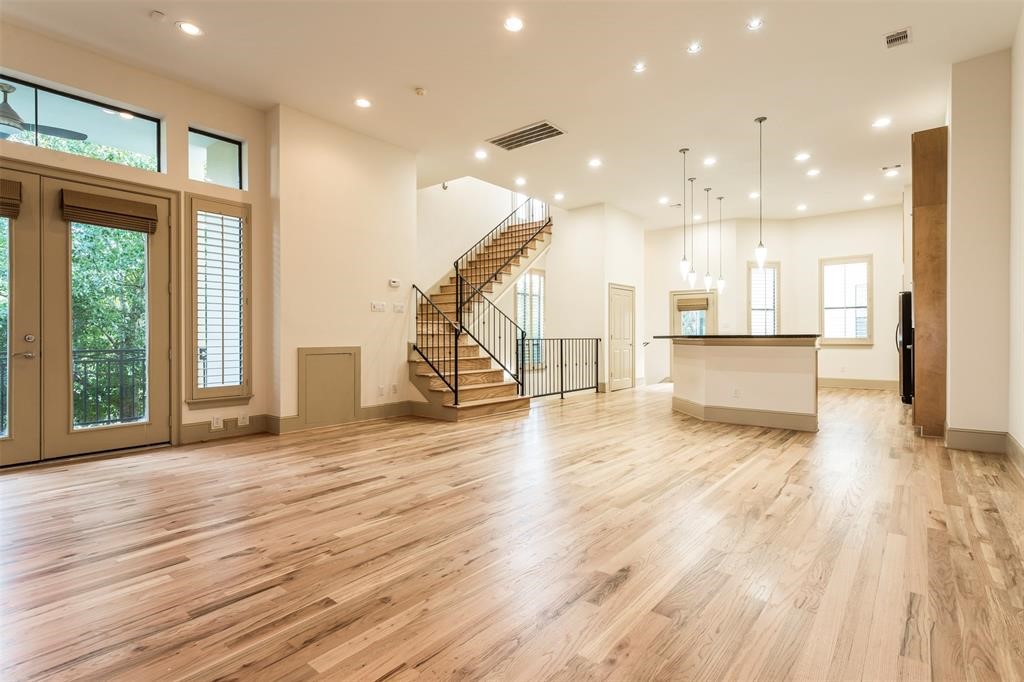 2034 Colquitt Street, Unit A Houston, TX 77098 - Photo 17 of 30 a view of a living room and a kitchen with wooden floors