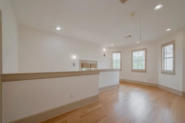 a view of a kitchen with a sink and wooden floor