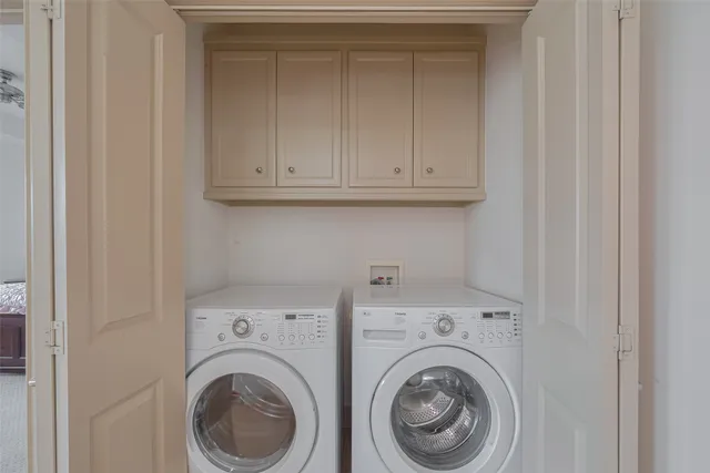 a view of storage and utility room with washer and dryer