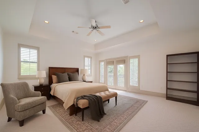 a bedroom with a bed a couch and window