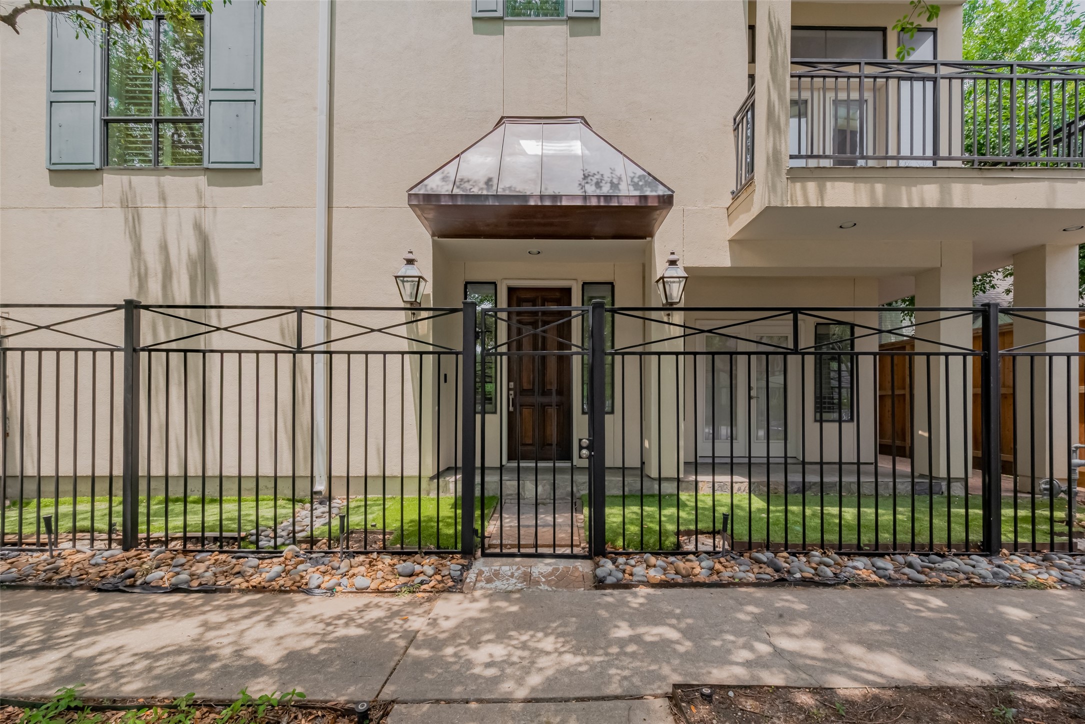 2034 Colquitt Street, Unit A Houston, TX 77098 - Photo 4 of 30 a view of a brick house with a small yard and plants