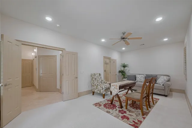 a dining room with furniture and a chandelier