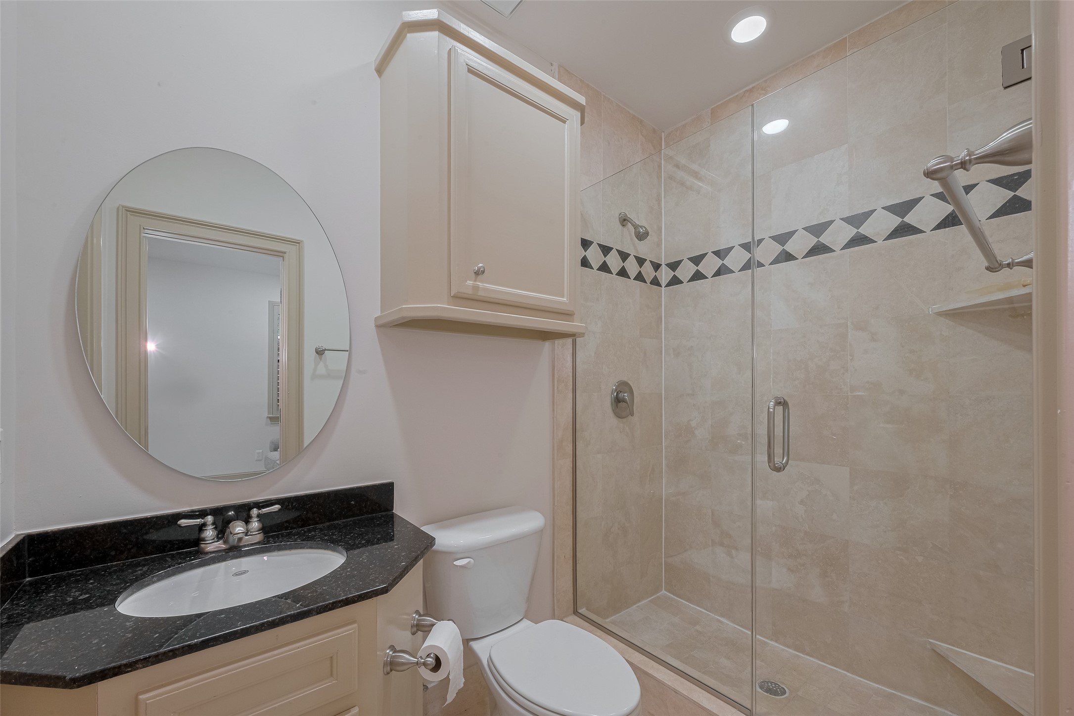 2034 Colquitt Street, Unit A Houston, TX 77098 - Photo 9 of 30 a bathroom with a granite countertop sink toilet a mirror and shower