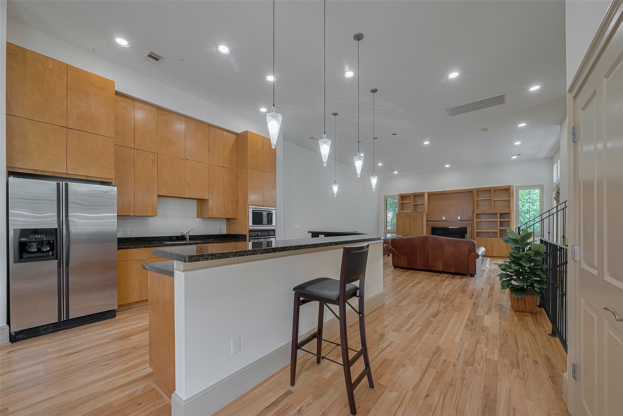 2034 Colquitt Street, Unit A Houston, TX 77098 - Photo 10 of 30 a kitchen with stainless steel appliances a stove a sink a refrigerator and a oven with wooden floor