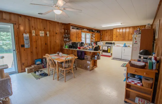 a bedroom with a bed and a flat tv screen on dresser