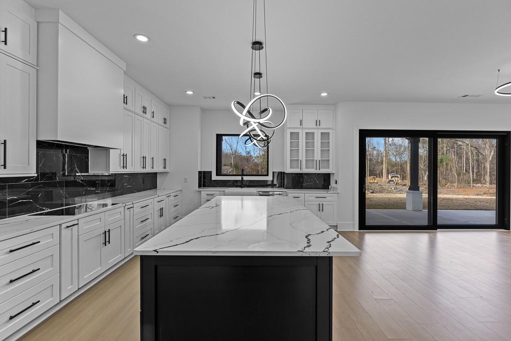 2404 Highway 124 Jefferson, GA 30549 - Photo 12 of 51 a large kitchen with granite countertop a sink a counter space cabinets and stainless steel appliances