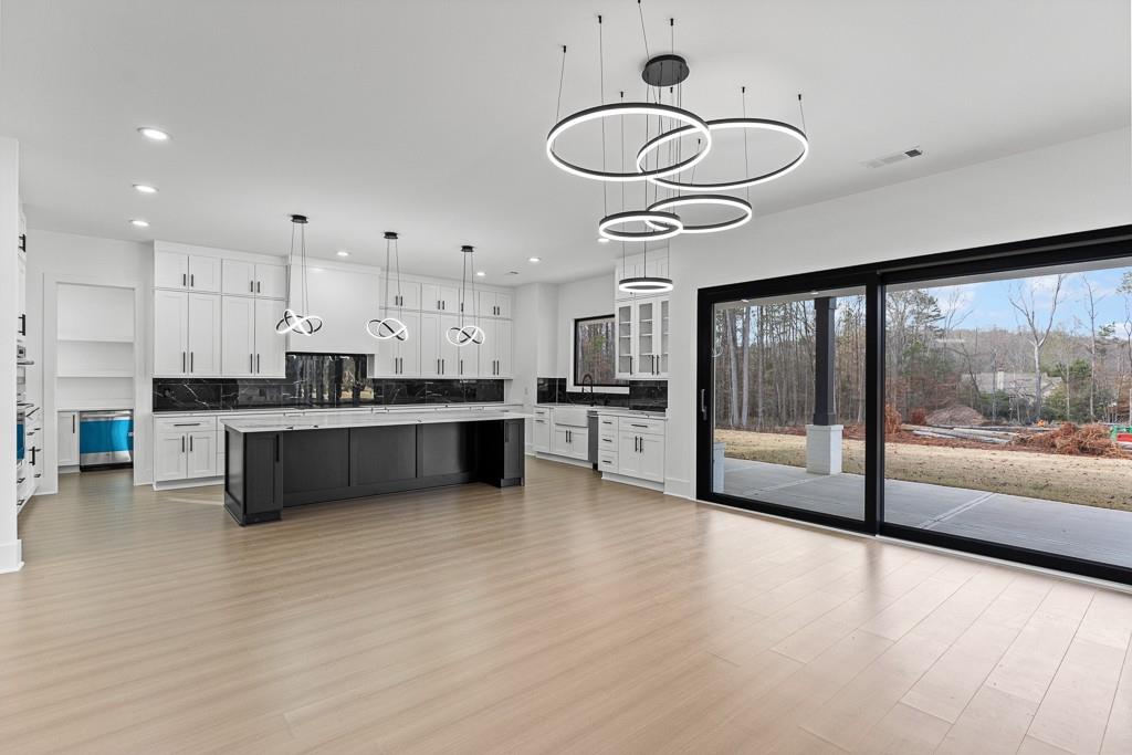 2404 Highway 124 Jefferson, GA 30549 - Photo 15 of 51 a kitchen with stainless steel appliances kitchen island granite countertop a stove a sink and a refrigerator