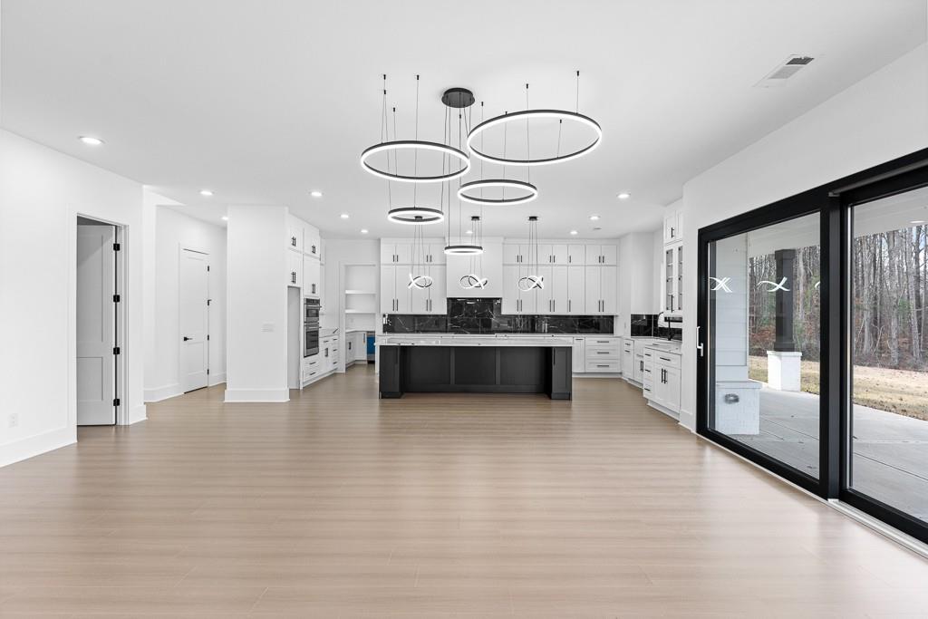 2404 Highway 124 Jefferson, GA 30549 - Photo 16 of 51 a large kitchen with stainless steel appliances kitchen island granite countertop a large cabinets a sink and a fireplace