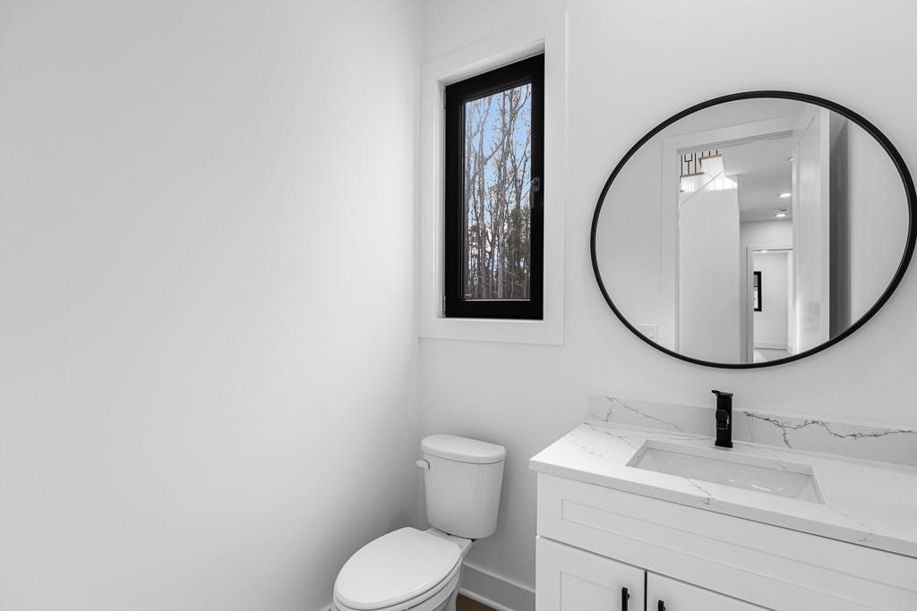 2404 Highway 124 Jefferson, GA 30549 - Photo 22 of 51 a bathroom with a toilet sink and mirror