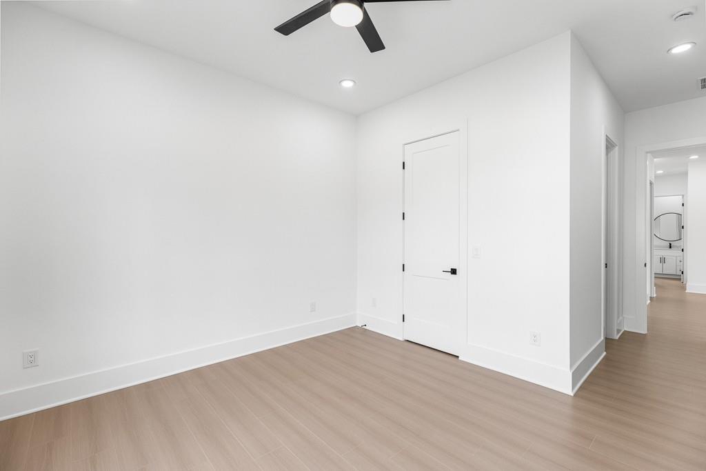 2404 Highway 124 Jefferson, GA 30549 - Photo 25 of 51 an empty room with wooden floor and ceiling fan