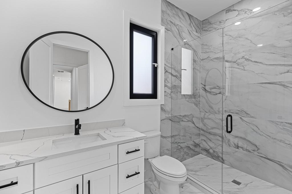 2404 Highway 124 Jefferson, GA 30549 - Photo 32 of 51 a bathroom with a sink a toilet and a mirror