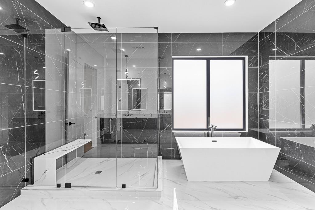 2404 Highway 124 Jefferson, GA 30549 - Photo 43 of 51 a bathroom with a tub a double vanity sink and mirror