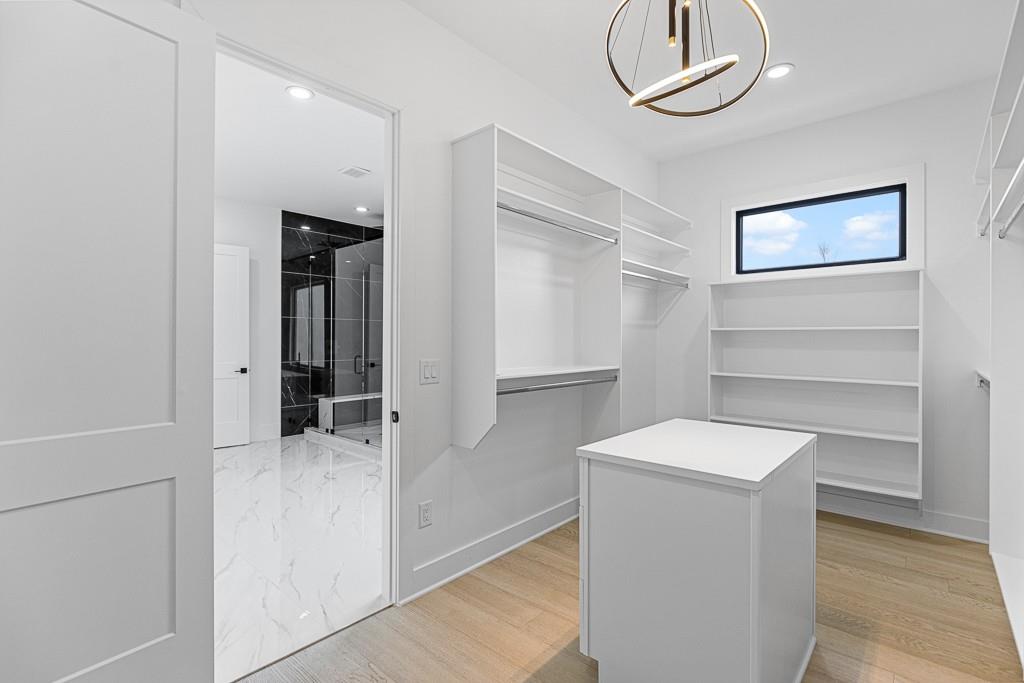 2404 Highway 124 Jefferson, GA 30549 - Photo 47 of 51 a room with a walk in closet and wooden floor