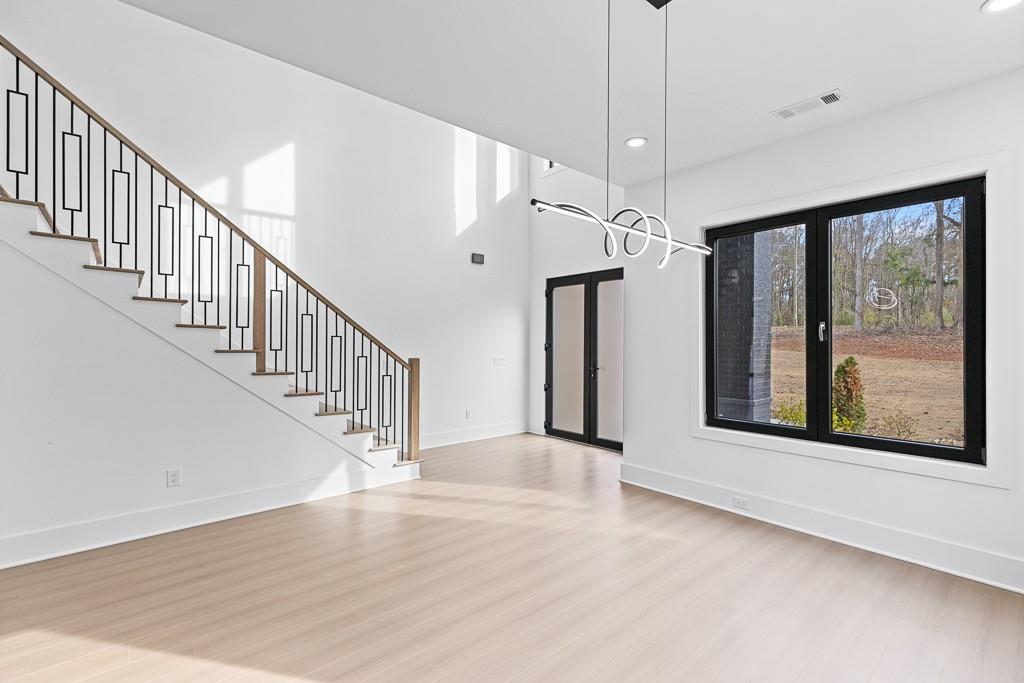 2404 Highway 124 Jefferson, GA 30549 - Photo 5 of 51 a view interior of a house with wooden floor a ceiling fan and windows