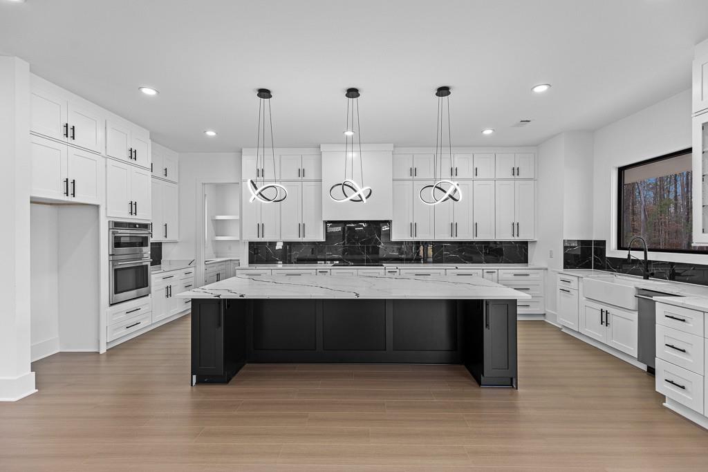 2404 Highway 124 Jefferson, GA 30549 - Photo 8 of 51 a large kitchen with kitchen island a sink stainless steel appliances and cabinets