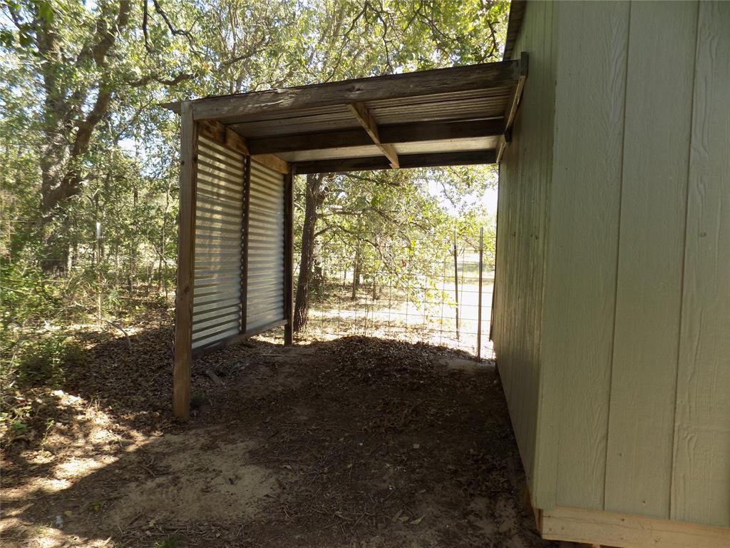 12792 Highway 199 Poolville, TX 76487 - Photo 8 of 24 Covered area off side of storage building for various uses