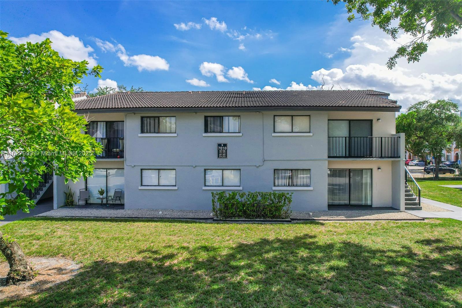 a front view of a house with a garden