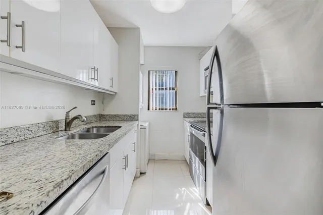 a kitchen with granite countertop a stove and a sink