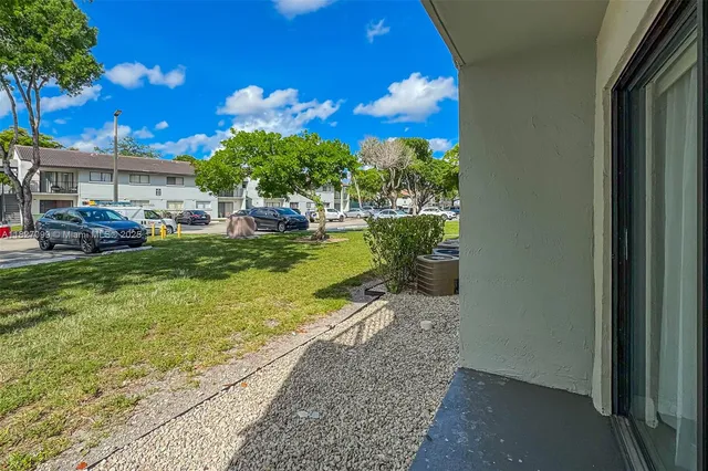an aerial view of a house with a yard and lake view