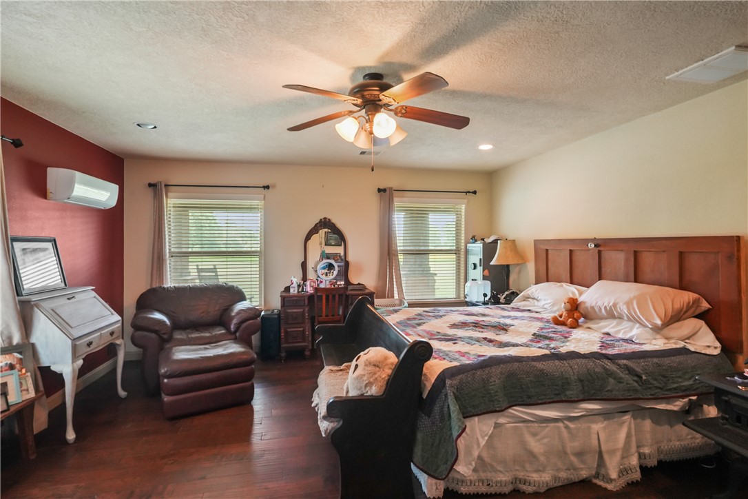 34366 Owens Road Hempstead, TX 77445 - Photo 22 of 31 a bedroom with a bed and wooden floor