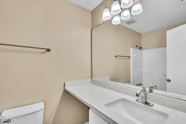 a bathroom with a sink vanity and a mirror