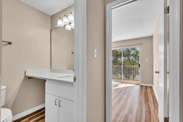 a view of bathroom with a toilet sink and mirror