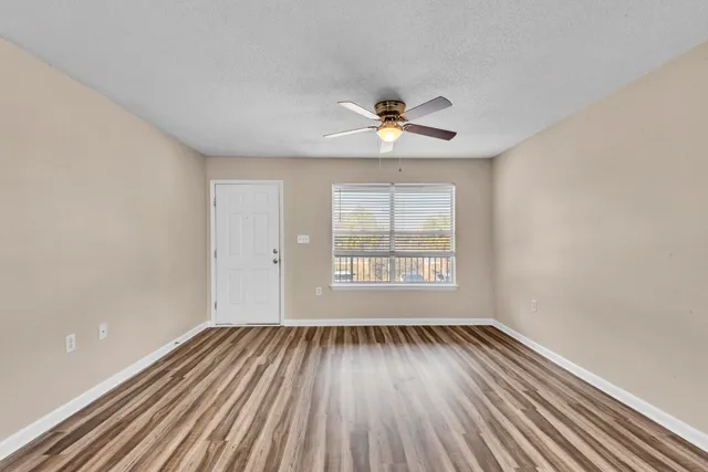 wooden floor in an empty room with a window